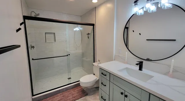 a bathroom with a sink a toilet and a mirror