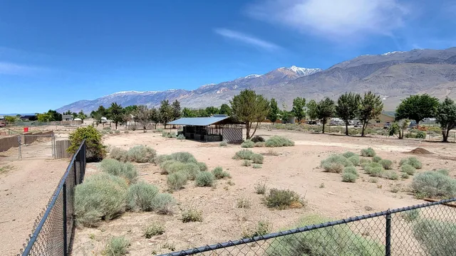 a view of a dry yard with a barn