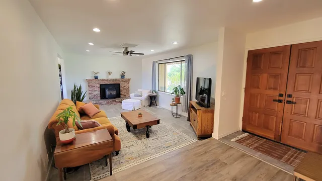 a living room with furniture and a fireplace