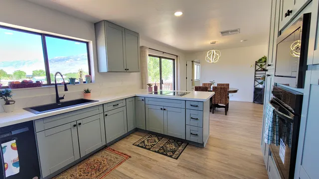 a kitchen with a sink stove and cabinets