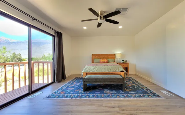 a room with a bed and wooden floor