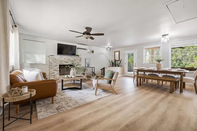 a living room with furniture fireplace and a flat screen tv