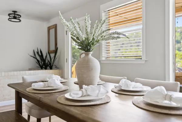 a view of a dining room with furniture and a potted plant