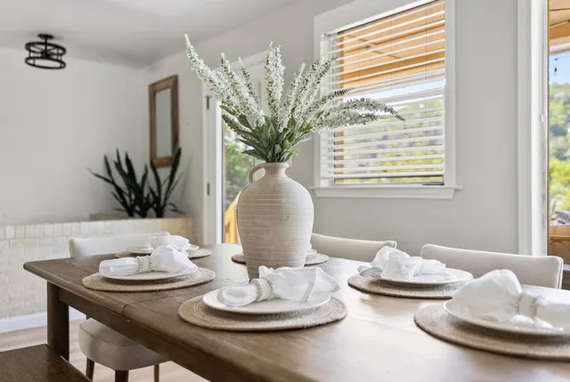 a view of a dining room with furniture and a potted plant