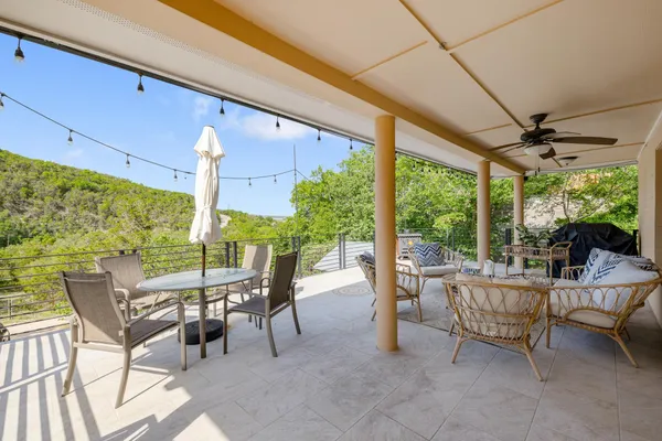 a building outdoor space with patio furniture and potted plants