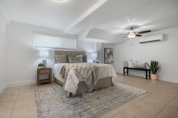 a bed room with a bed and a chandelier
