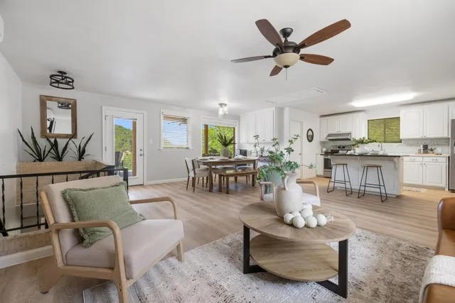 a living room with furniture and kitchen view