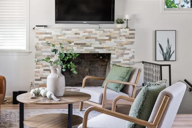a living room with furniture and a fireplace