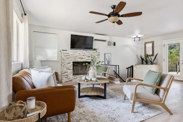 a living room with furniture fireplace and a flat screen tv