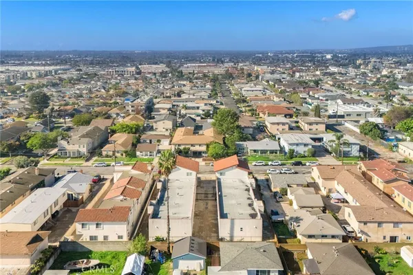 an aerial view of a city with lots of residential buildings and parking space