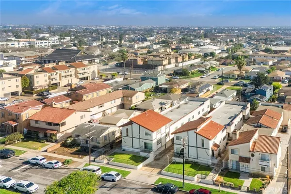 an aerial view of residential houses with city view