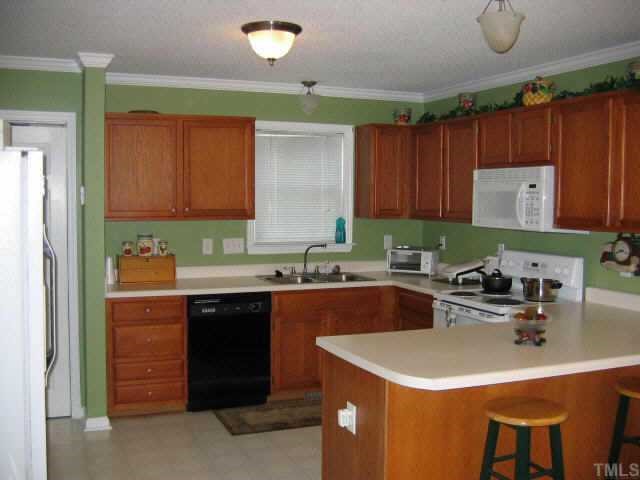 2033 Ruddy Road Raleigh, NC 27616 - Photo 6 of 9 a kitchen with a sink a stove and cabinets