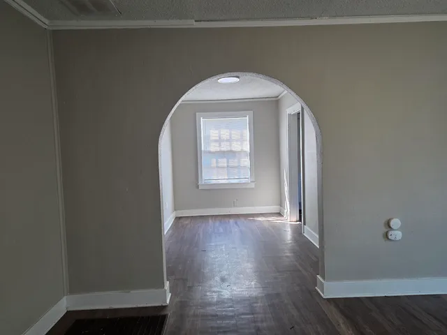 a view of a livingroom with wooden floor and window