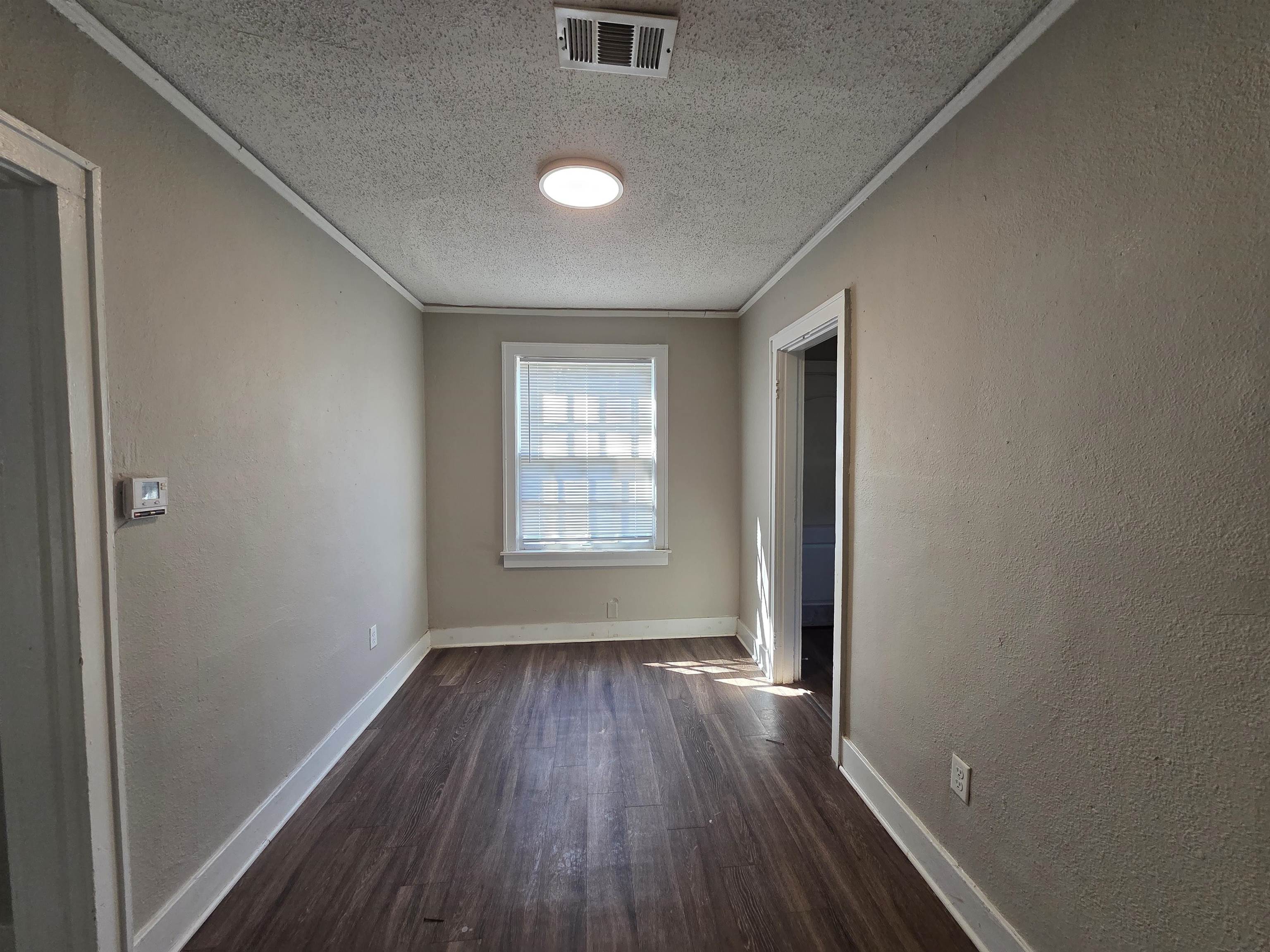 775 Pope Street Memphis, TN 38112 - Photo 7 of 13 an empty room with wooden floor and windows
