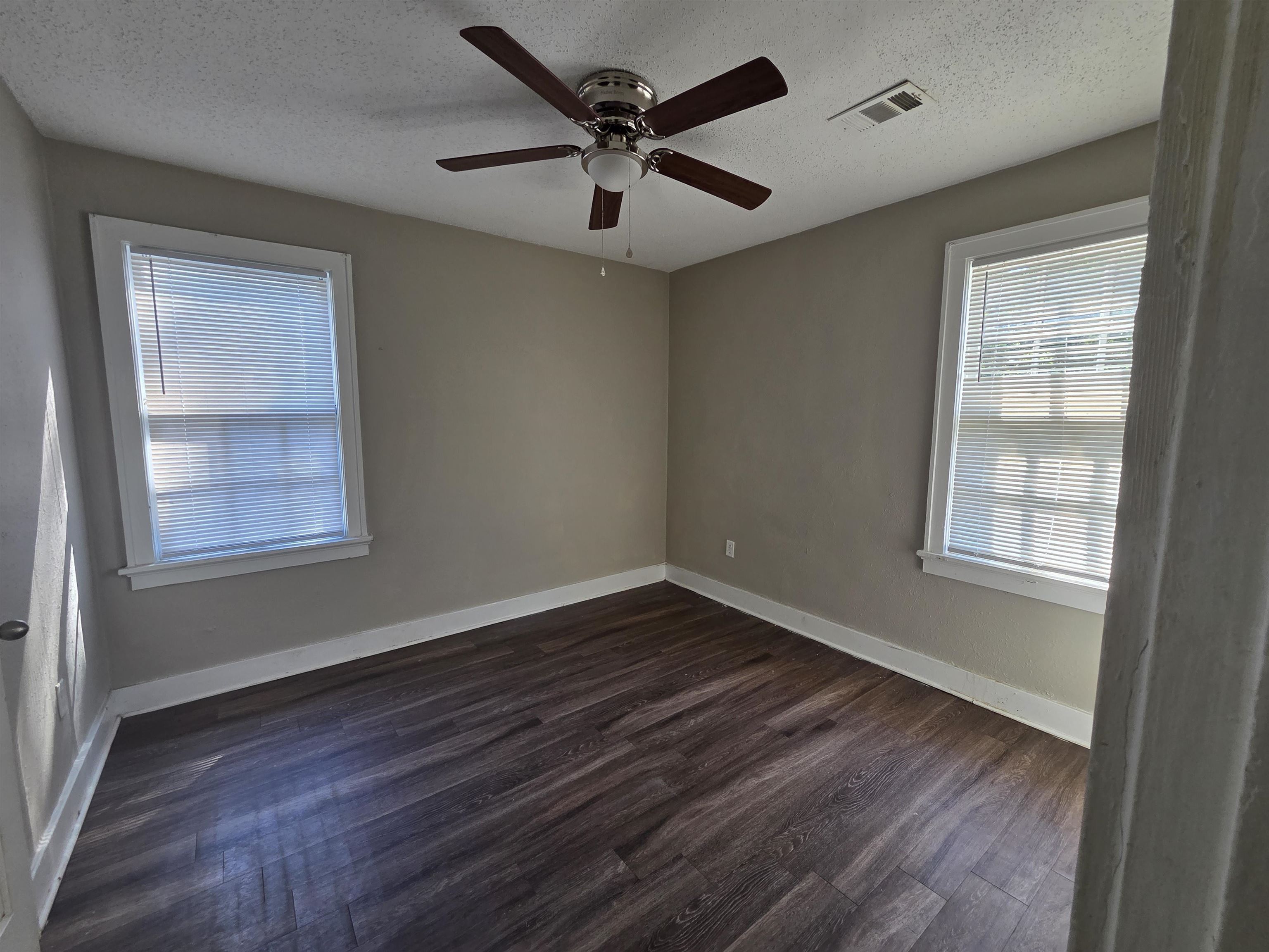775 Pope Street Memphis, TN 38112 - Photo 10 of 13 a view of an empty room with wooden floor and a window