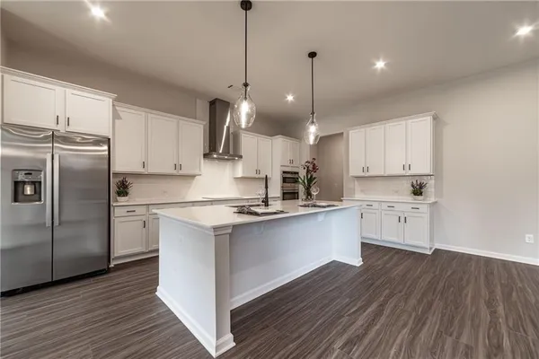 a kitchen with white cabinets and a sink