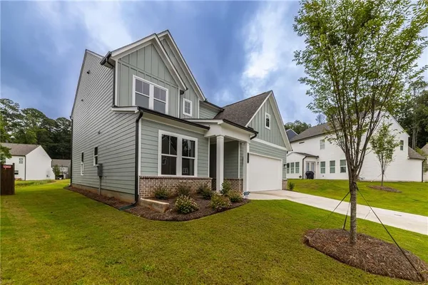 a front view of a house with a yard
