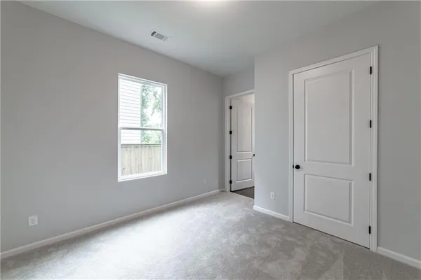 a white bath tub sitting in a bathroom next to a window