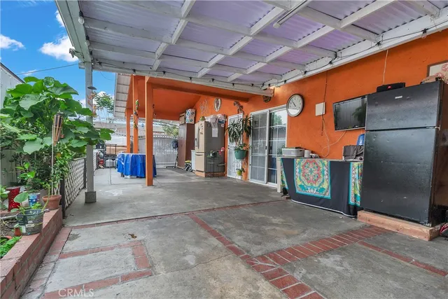 a view of porch with a table and chairs and potted plants