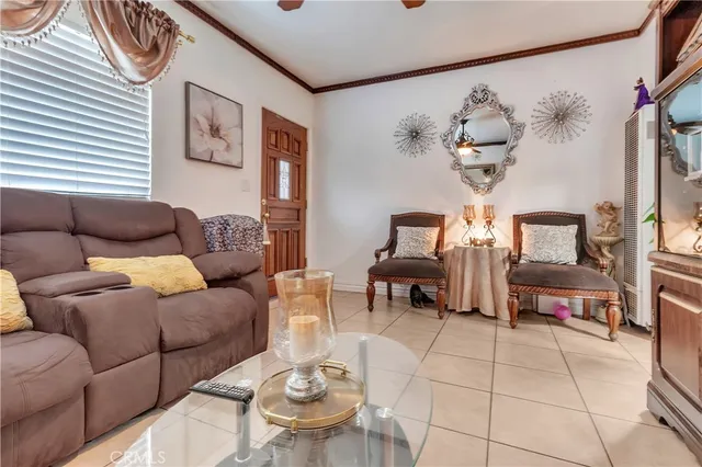 a living room with furniture a dining table and a chandelier