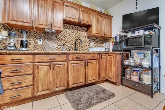 a kitchen with stainless steel appliances granite countertop a refrigerator and microwave