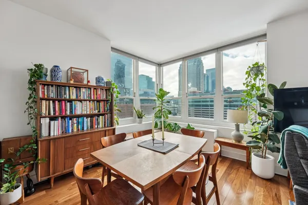 a view of a dining room with furniture window and wooden floor