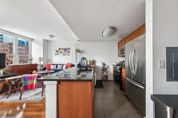 a view of a kitchen with refrigerator and windows