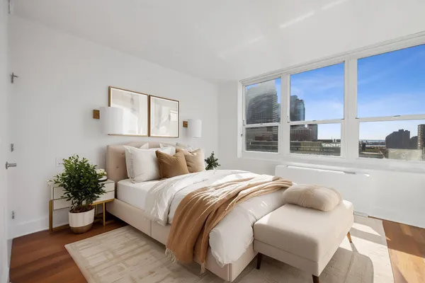 a bedroom with a bed and window