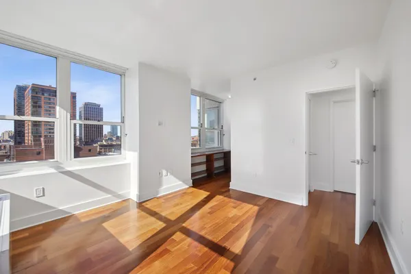 a bedroom with a bed and a wooden floor