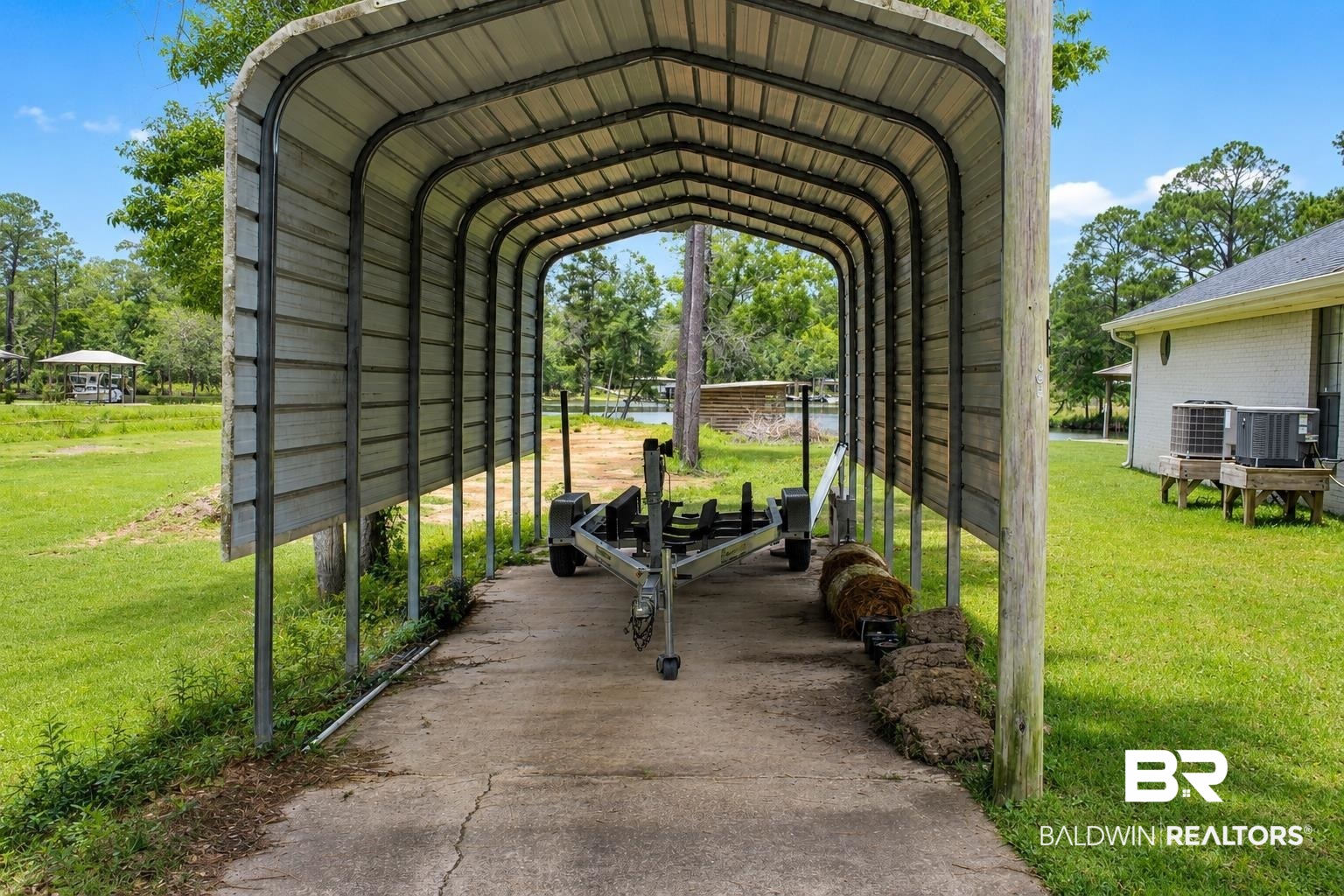 9825 Wolf Creek Ridge Elberta, AL 36530 - Photo 56 of 76 Metal carport with a concrete drive