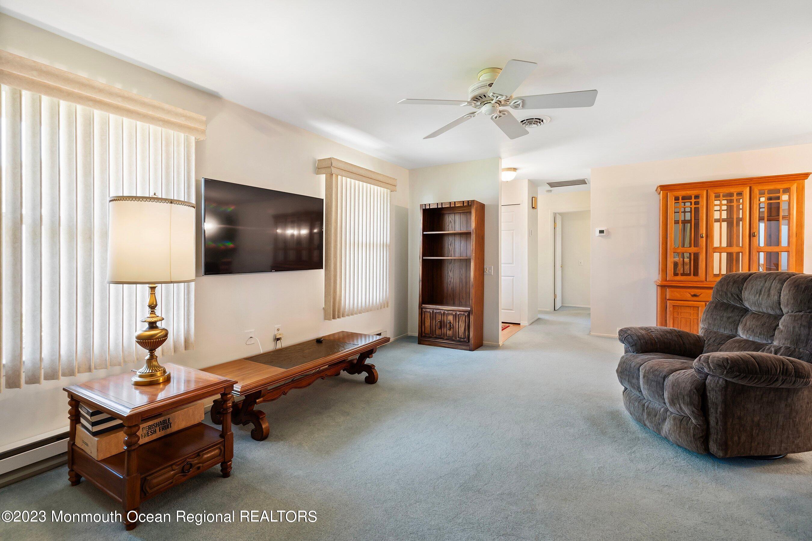 9 Amherst Road, Unit 64 Whiting, NJ 08759 - Photo 13 of 30 a living room with furniture and a flat screen tv