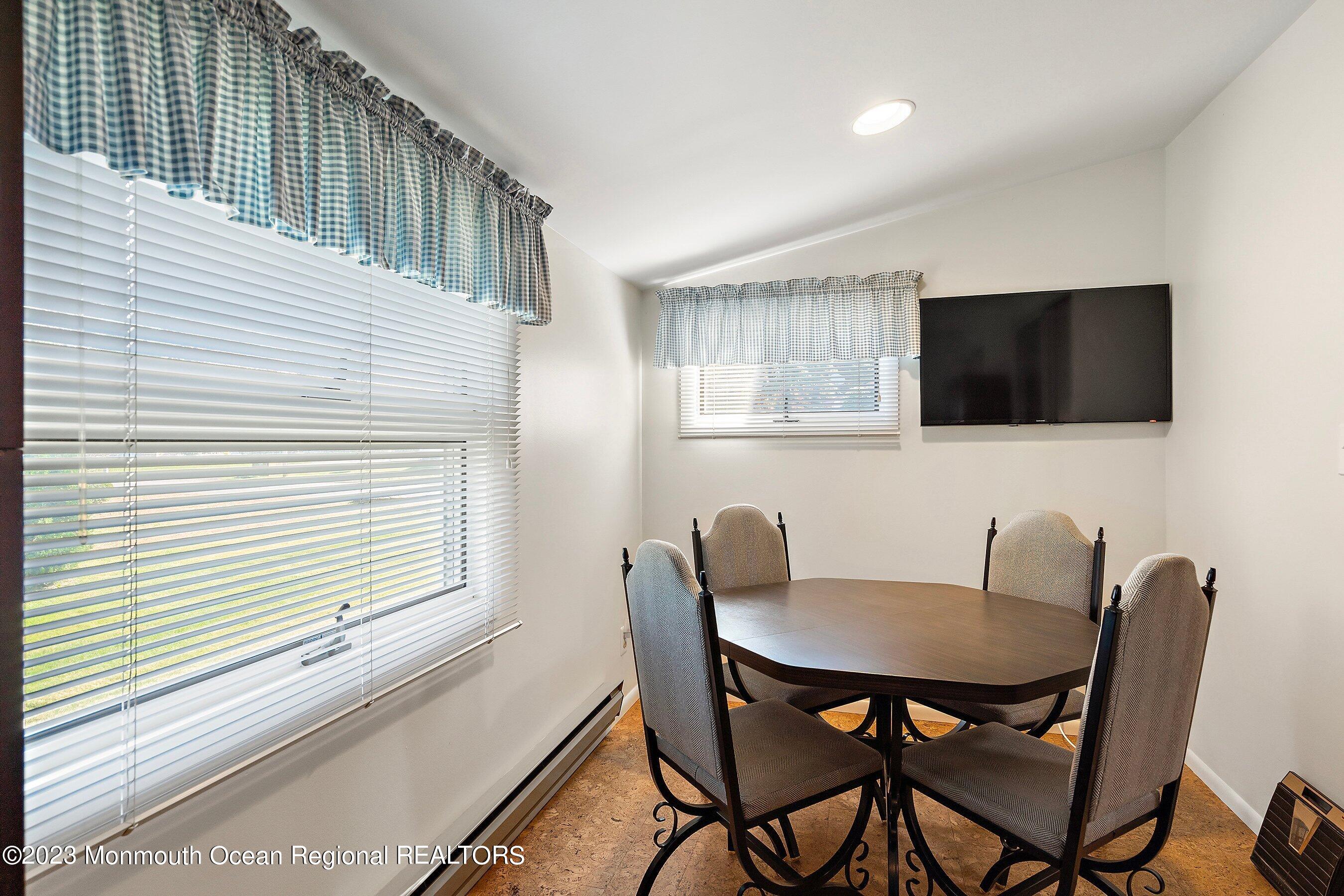 9 Amherst Road, Unit 64 Whiting, NJ 08759 - Photo 14 of 30 a view of a dining room with furniture and a window