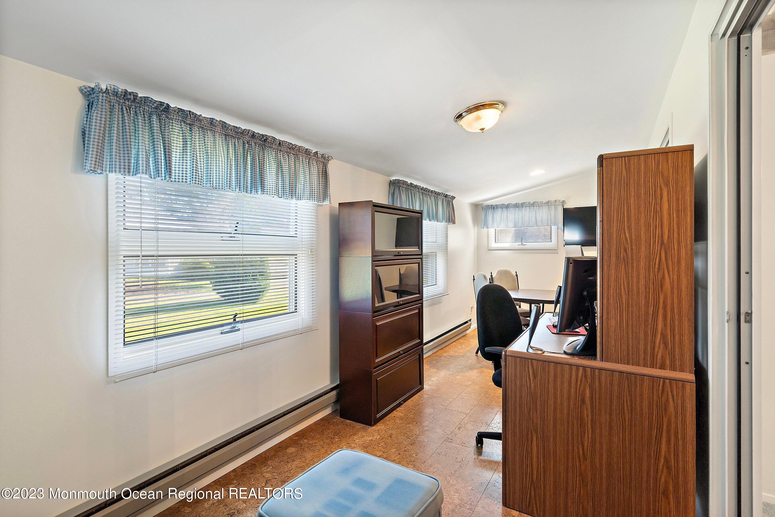 9 Amherst Road, Unit 64 Whiting, NJ 08759 - Photo 15 of 30 a kitchen with stainless steel appliances kitchen island granite countertop a refrigerator and a stove