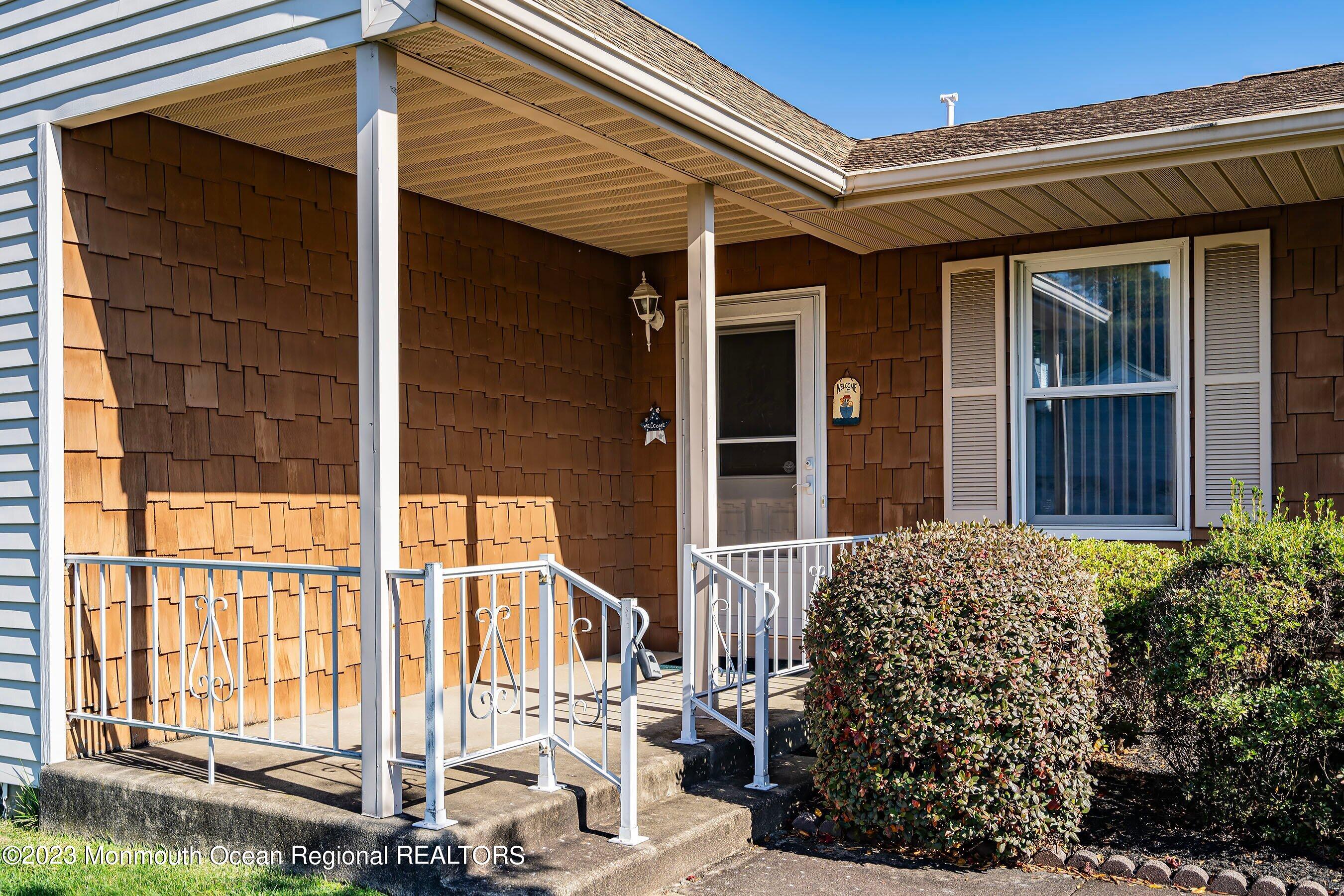 9 Amherst Road, Unit 64 Whiting, NJ 08759 - Photo 2 of 30 a view of a house with a large window and yard