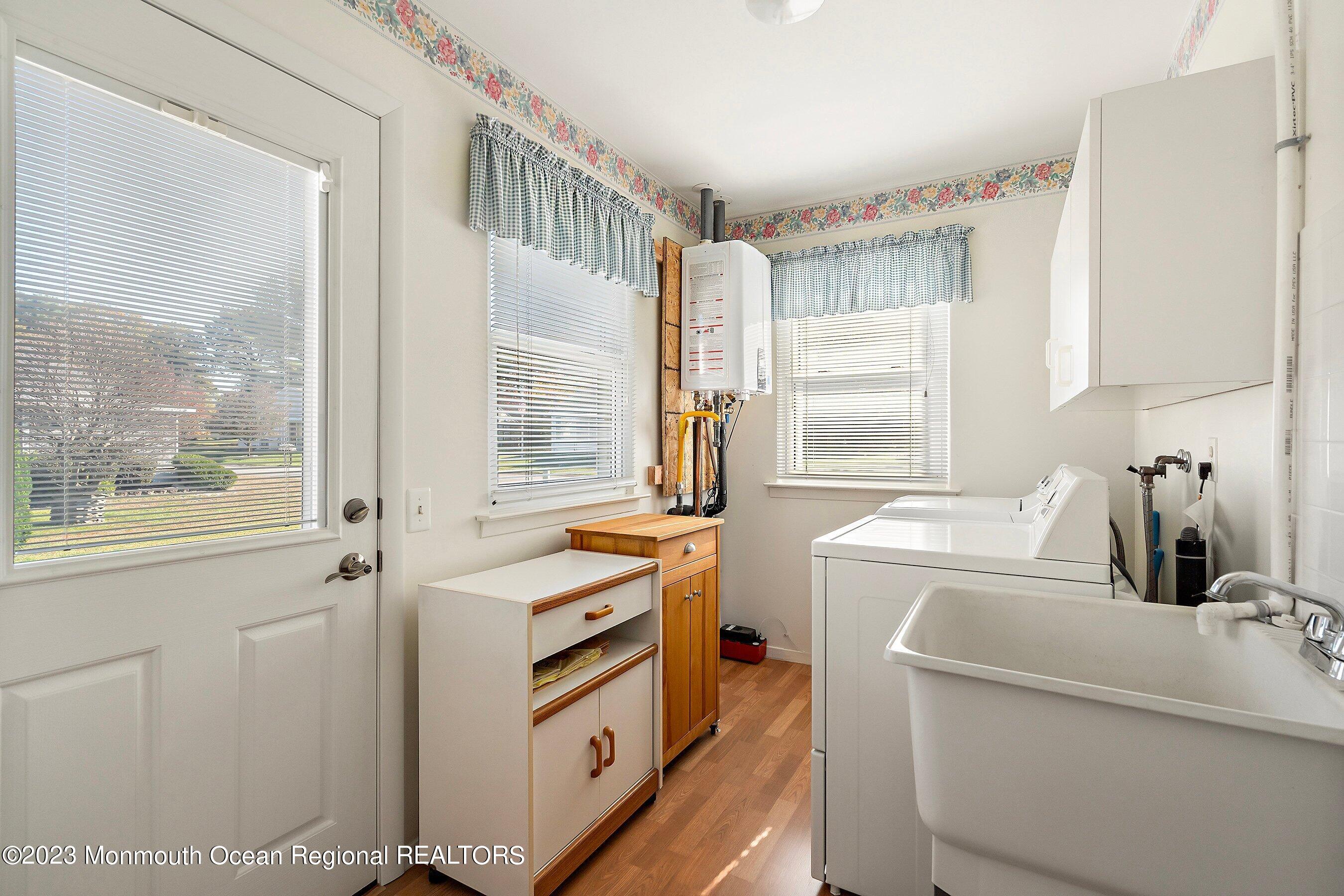 9 Amherst Road, Unit 64 Whiting, NJ 08759 - Photo 23 of 30 a kitchen with a sink and a refrigerator