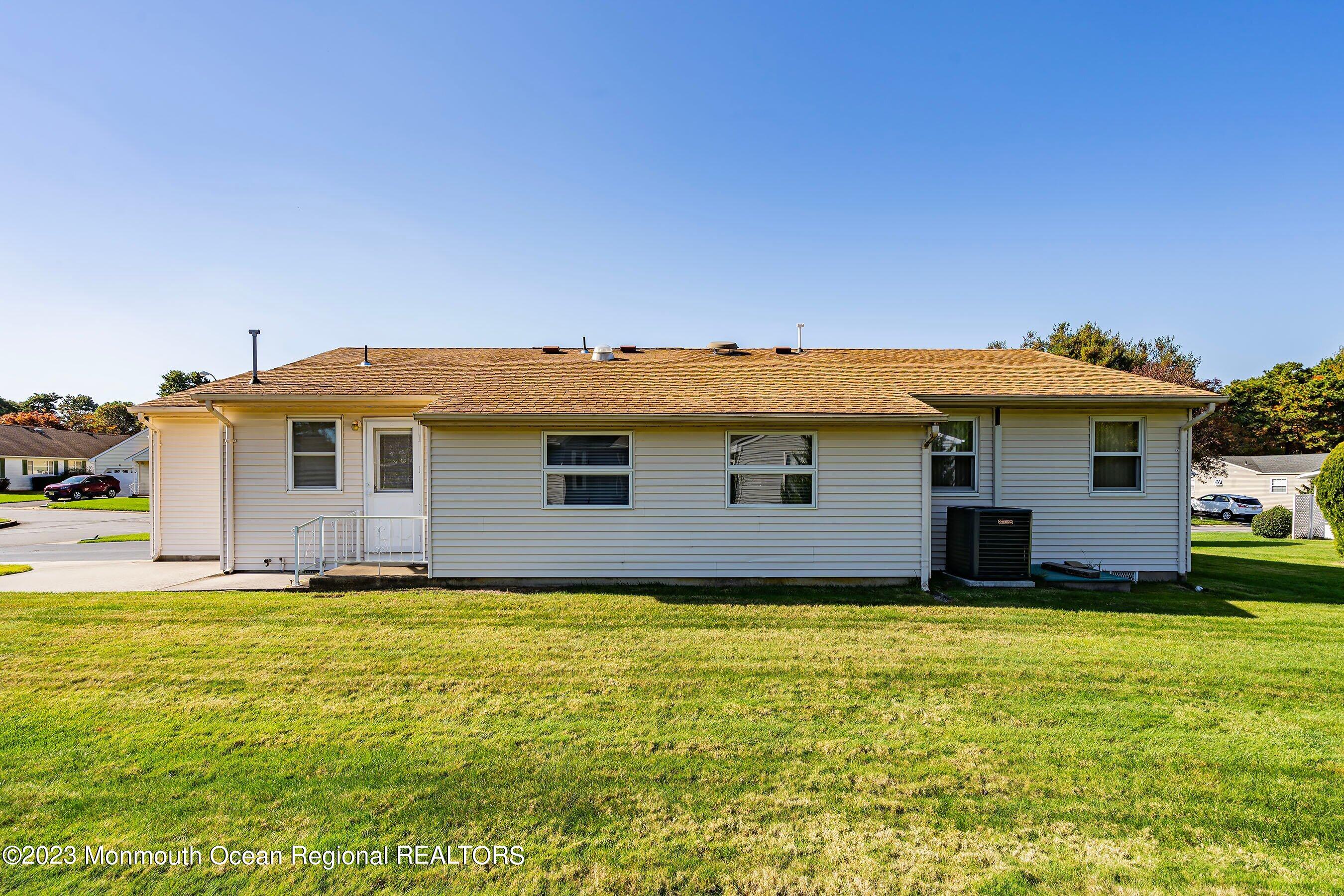 9 Amherst Road, Unit 64 Whiting, NJ 08759 - Photo 27 of 30 a view of a house with a yard