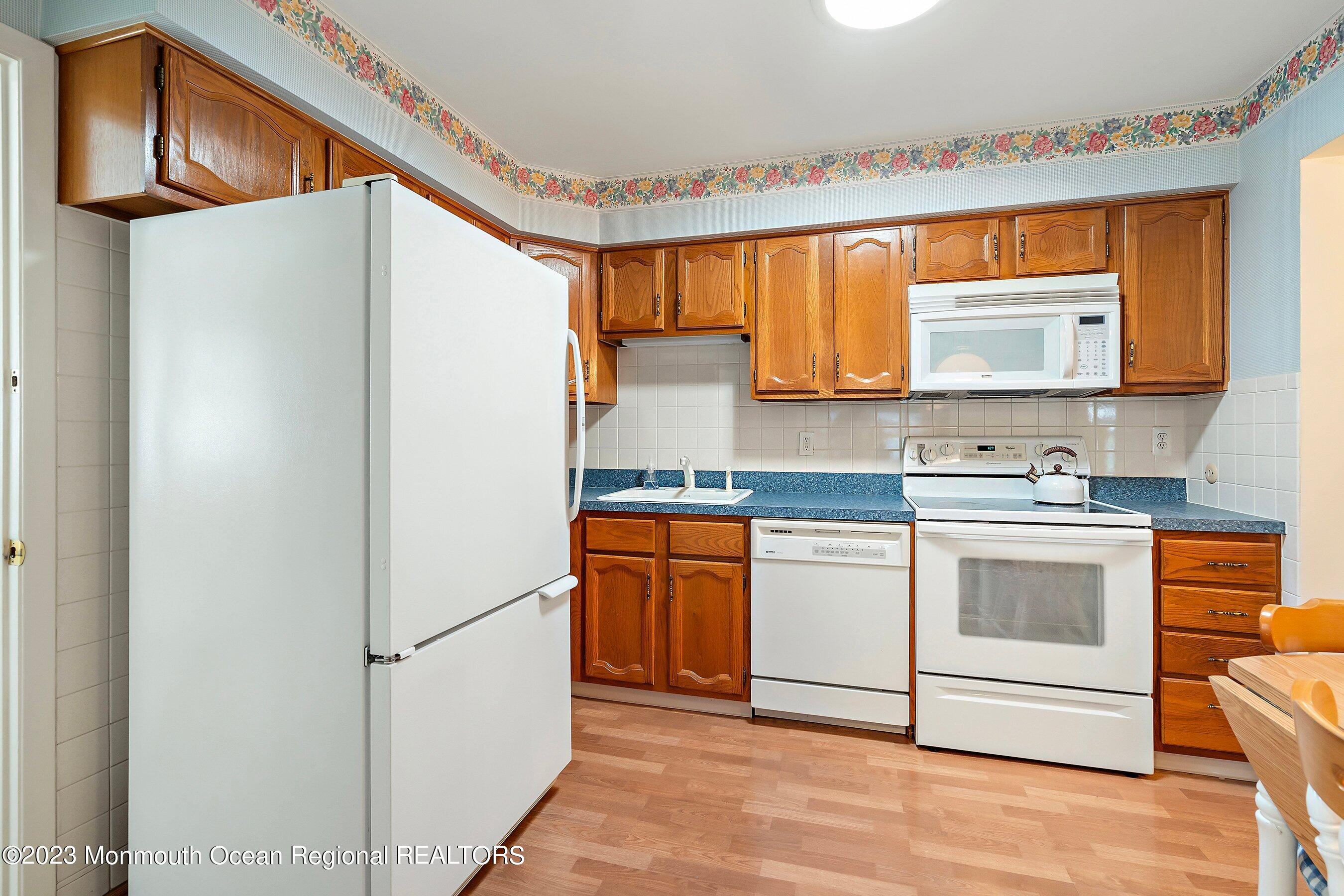 9 Amherst Road, Unit 64 Whiting, NJ 08759 - Photo 6 of 30 a kitchen with stainless steel appliances granite countertop a refrigerator sink and cabinets