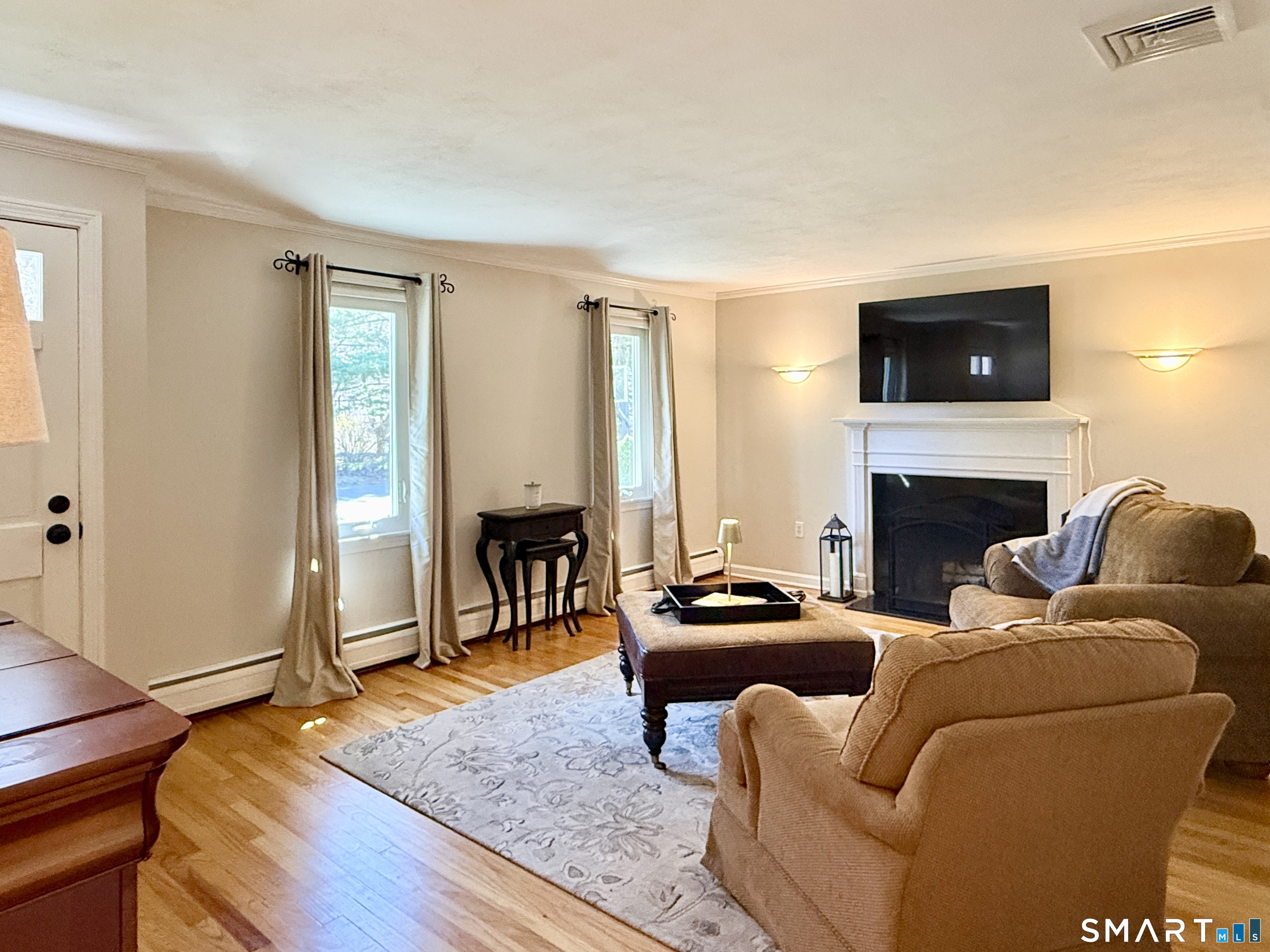 17 Sunnybrook Drive Avon, CT 06001 - Photo 14 of 40 a living room with furniture a flat screen tv and a fireplace