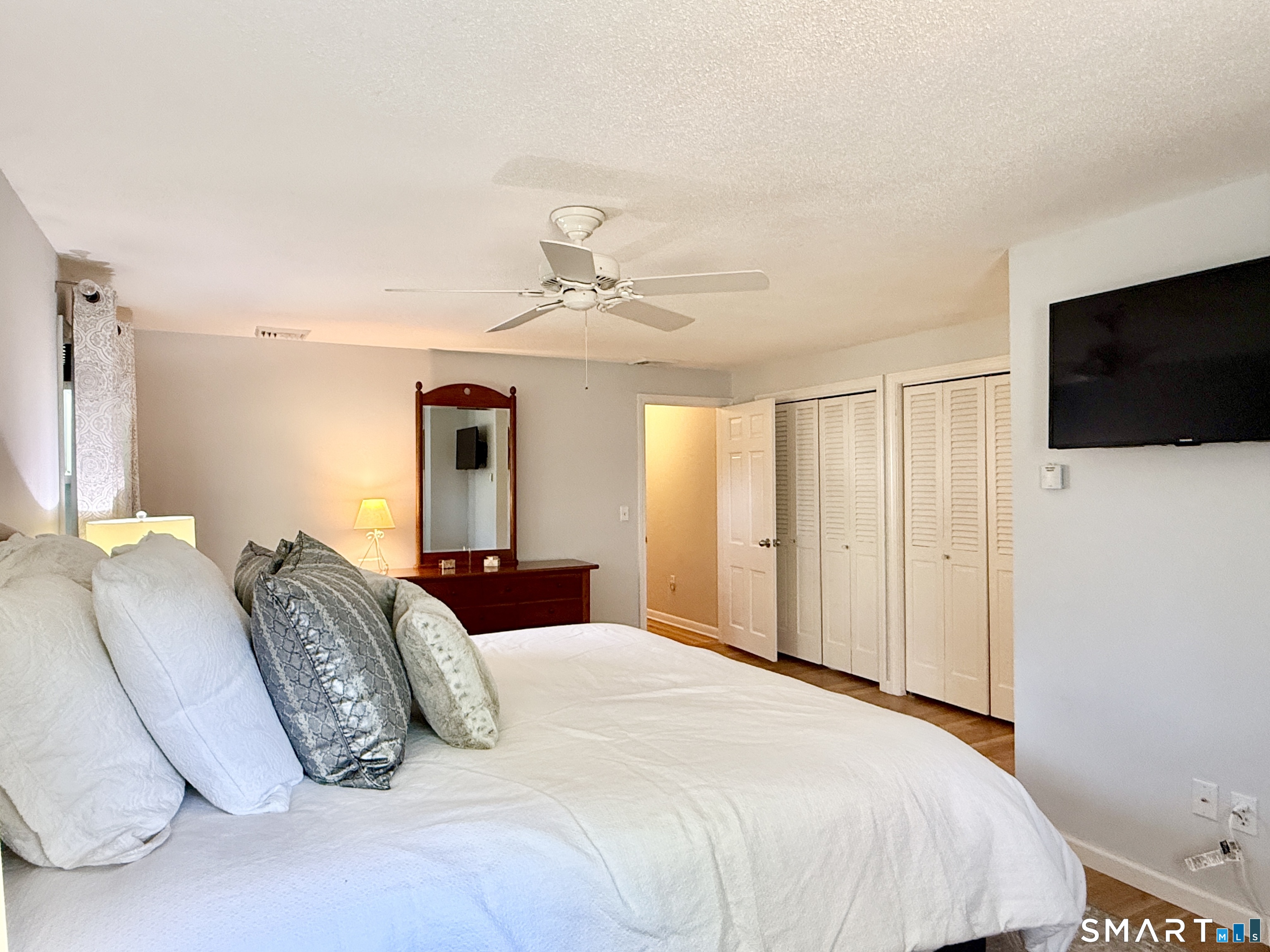 17 Sunnybrook Drive Avon, CT 06001 - Photo 18 of 40 a bedroom with a large bed and a flat screen tv