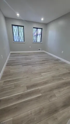a view of room with window and hardwood floor