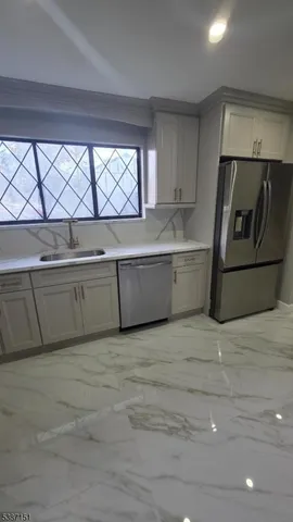 a view of a kitchen with a sink and a dishwasher