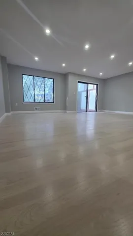 an empty room with windows and brick walls