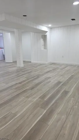 an empty room with wooden floor