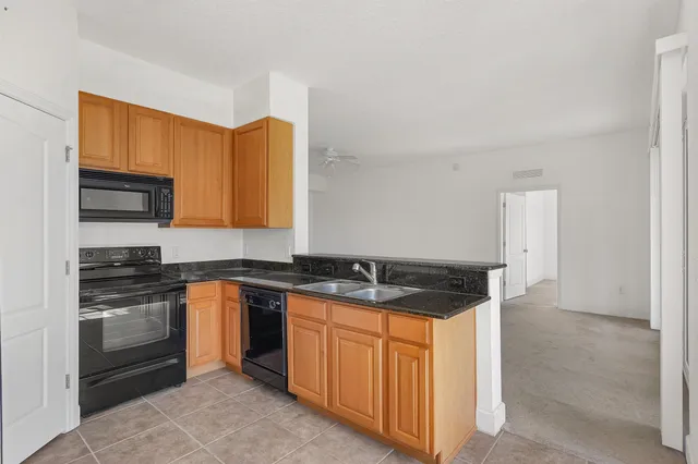 a kitchen with granite countertop a sink and cabinets