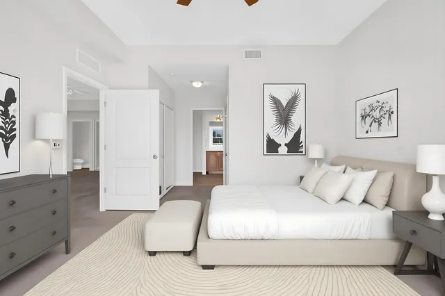 a spacious bedroom with a large bed and a couch