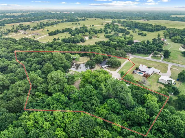 an aerial view of a city with lots of residential buildings ocean and mountain view in back
