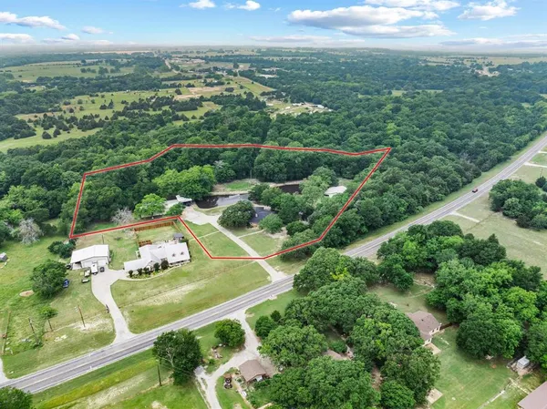an aerial view of residential houses with outdoor space and city view