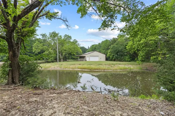 a view of a water fountain with a yard