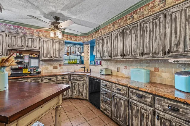 a kitchen with stainless steel appliances granite countertop a sink a stove and cabinets