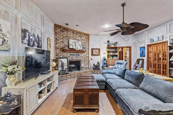 a living room with furniture a flat screen tv and a fireplace